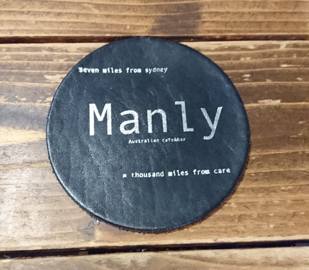 テーブルにあるコースター　Manlyと書かれている